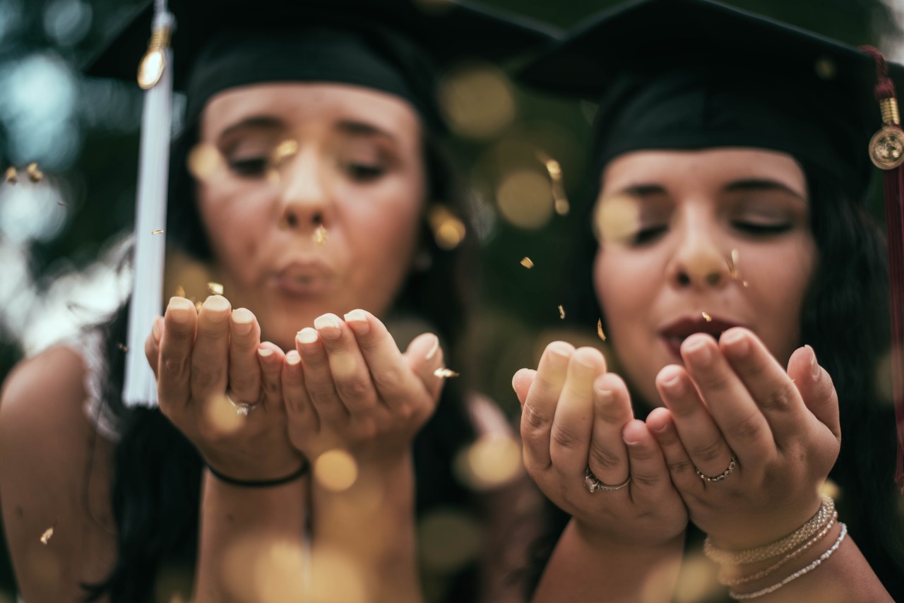 two graduates at graduation