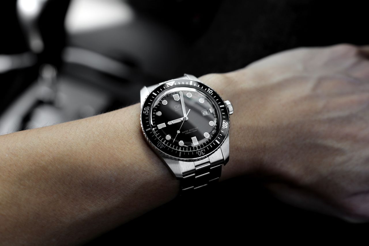 Black and steel timepiece worn on a man’s wrist
