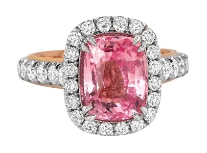 A Jack Kelege fashion ring features a stunning pink sapphire with a diamond halo and rose gold accented shank