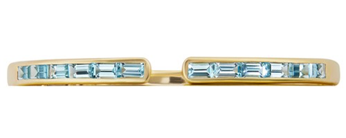Jane Taylor has designed a 14k yellow gold cuff with a series of blue topaz emerald-cut diamonds set on the end
