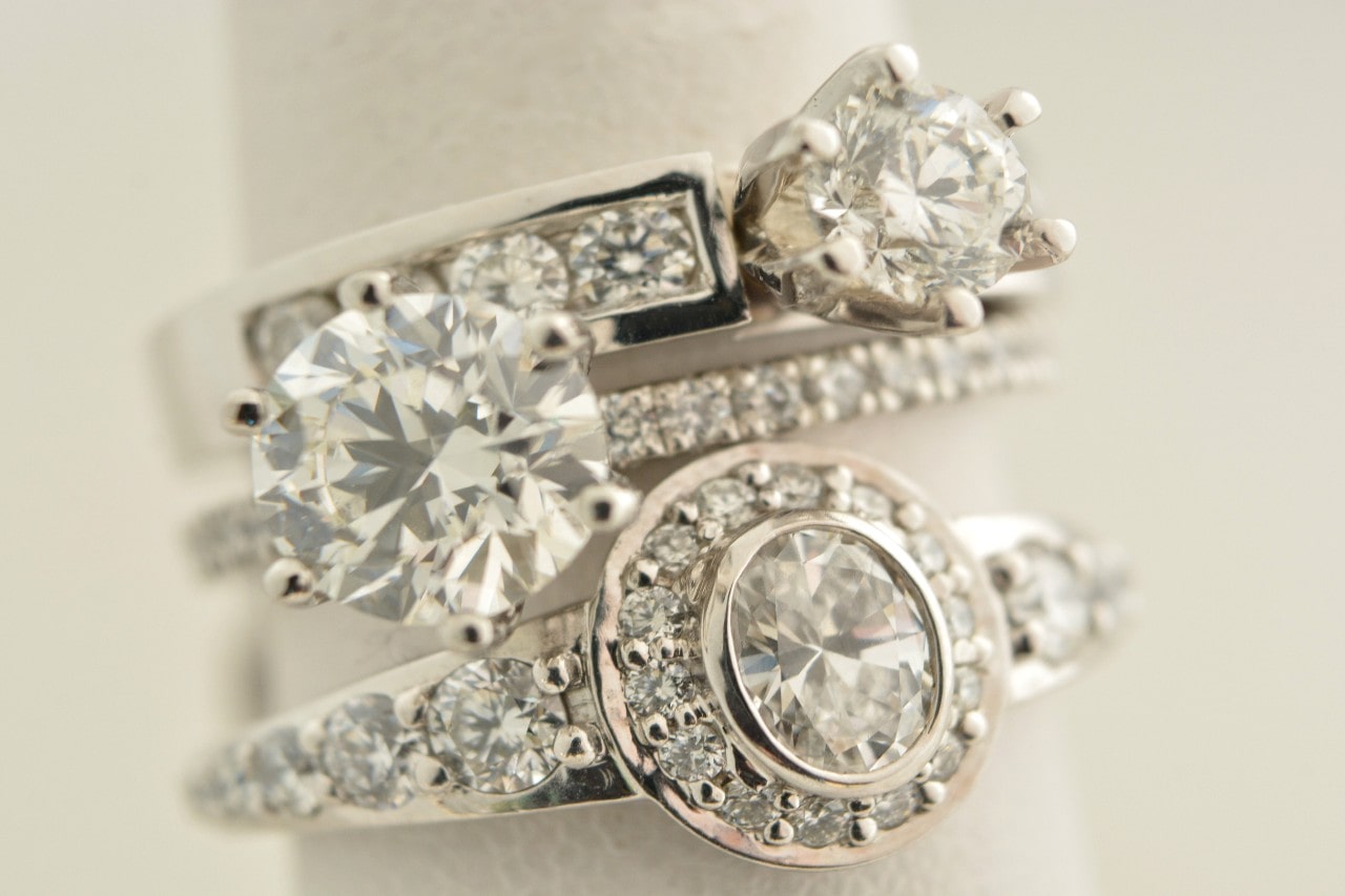 Three engagement rings at a jewelry store feature diamond alternatives