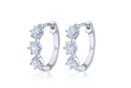 A pair of white gold hoop earrings with three prong-set diamonds