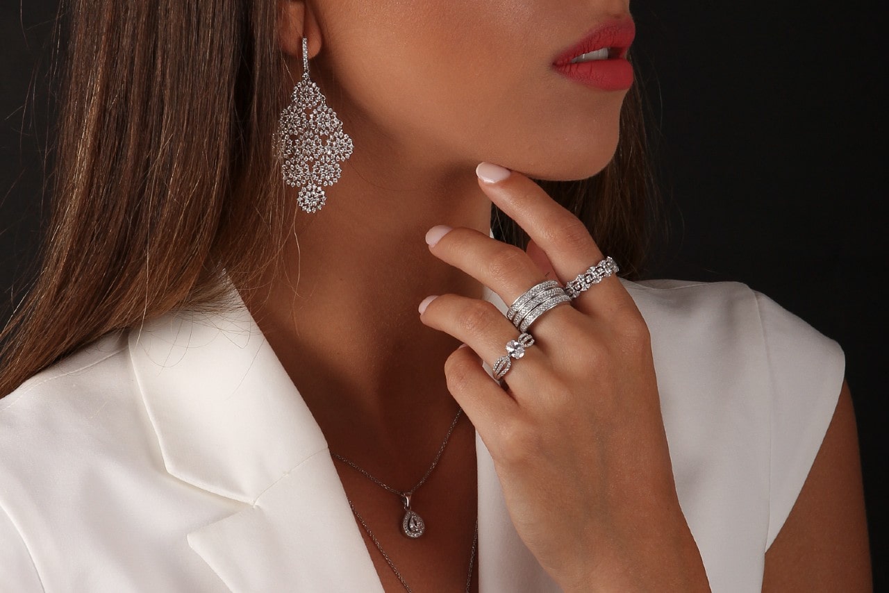 Woman in white wearing diamond jewelry