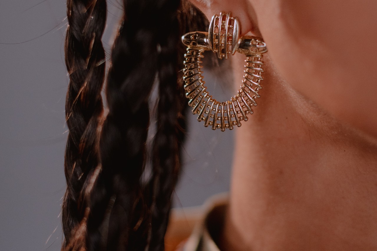 Close up image of a person wearing a bold, statement earring
