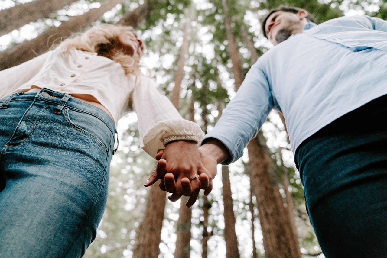 Couple holding hands in the forest