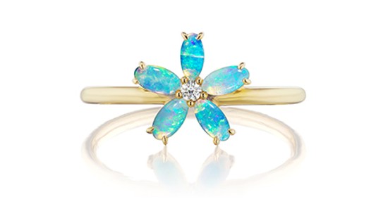 a yellow gold fashion ring featuring opals arranged into a flower