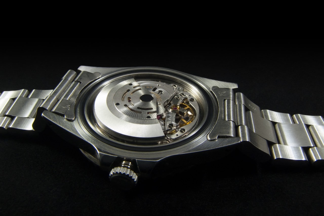 a view of the back of a stainless steel watch.