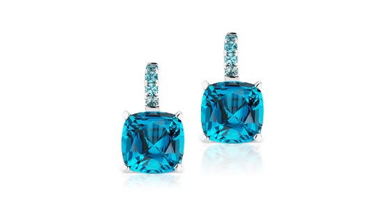 a pair of drop earrings featuring large blue gemstones