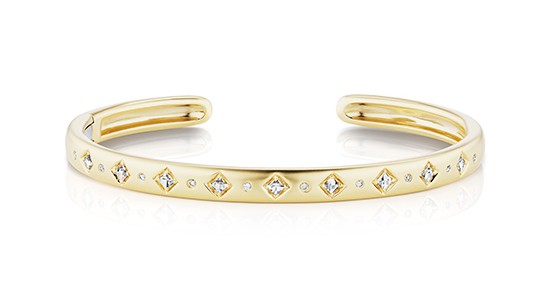 a yellow gold cuff bracelet set with round and princess cut diamonds