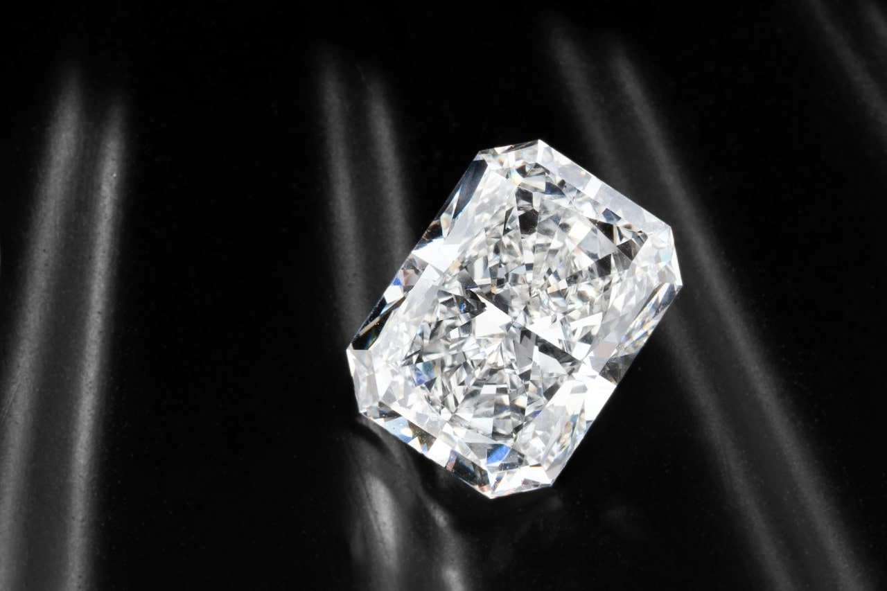 A radiant diamond against a black silk background