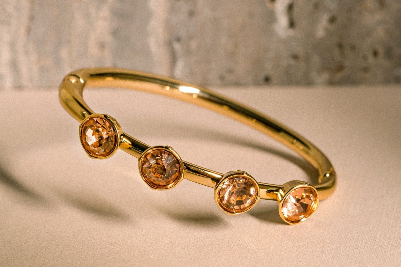 a yellow gold fashion ring featuring four citrine stones