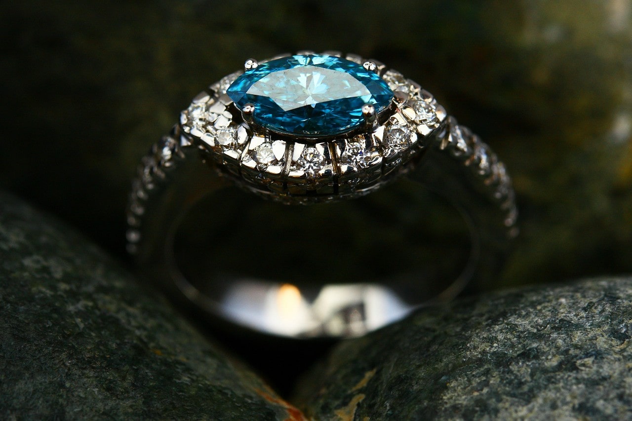 a white gold engagement ring with a blue marquise cut center stone