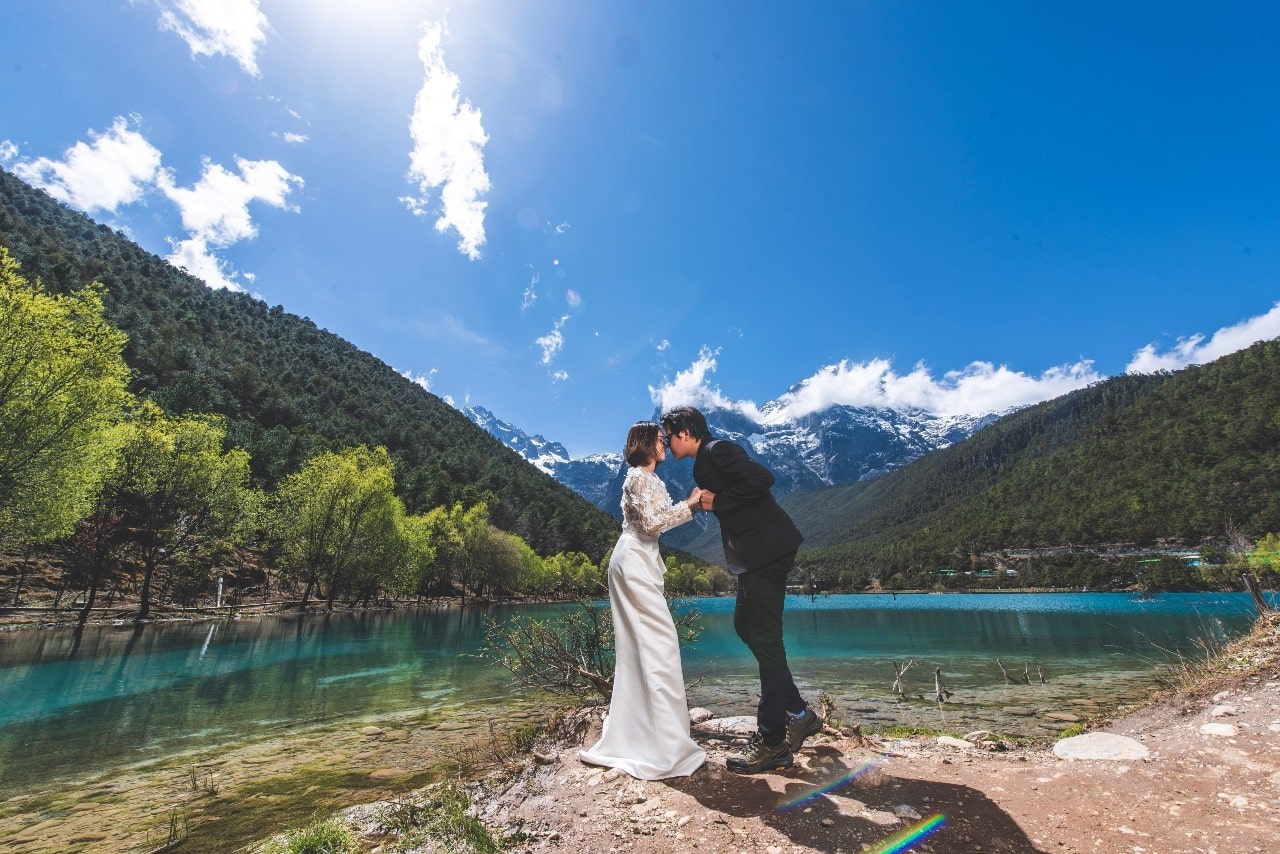 A couple elopes at a shore at a local lake.